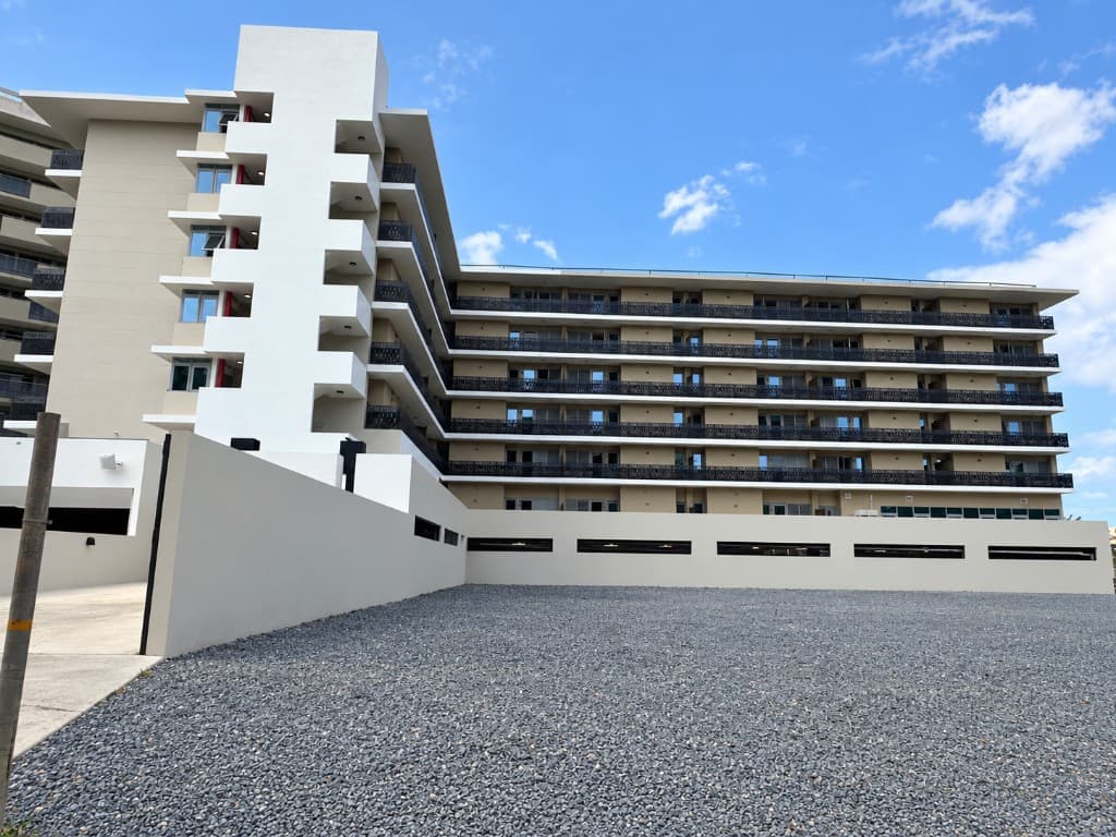 Residential tower balconies with waterjet-cut perforated railing panels