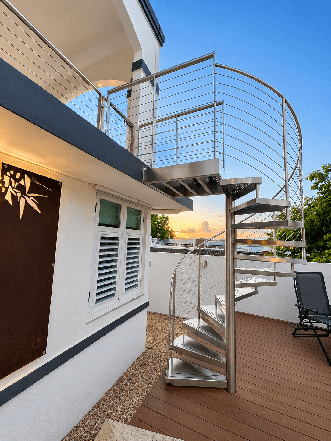 Stainless steel spiral staircase with cable railing