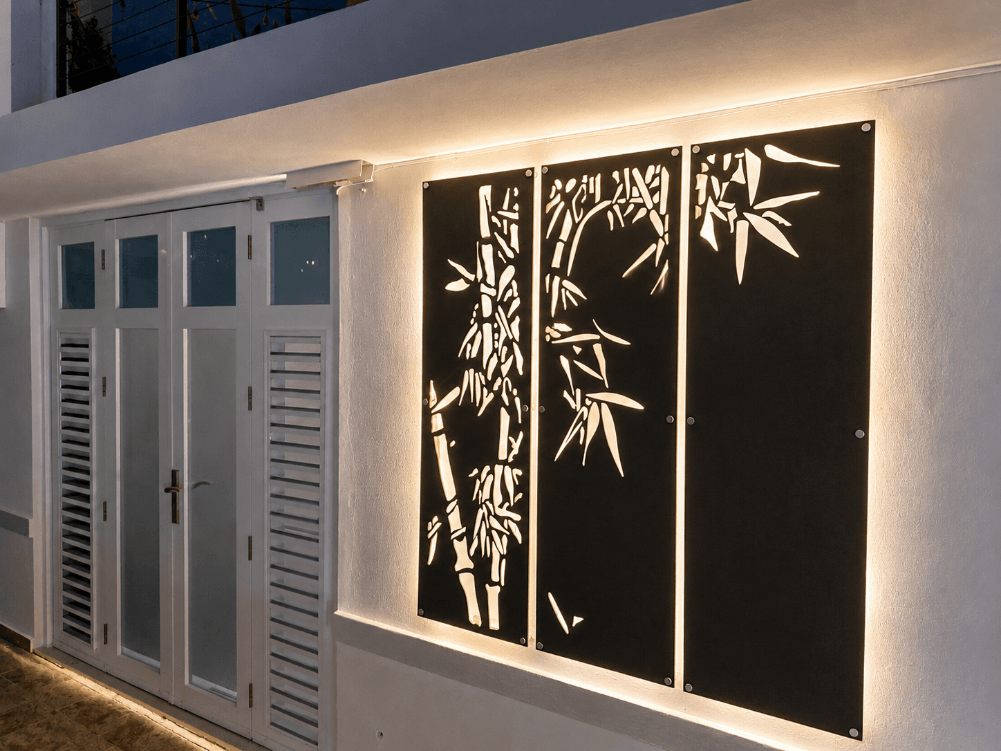 Backlit bamboo triptych on exterior wall